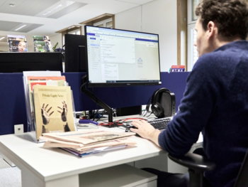 Man working at a computer in an office.