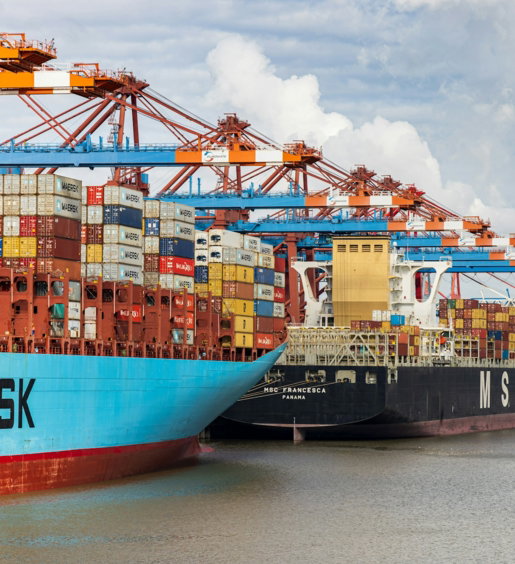 blue and red cargo ship on dock during daytime